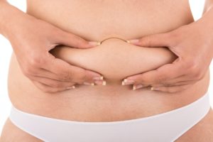 Woman showing her fat body